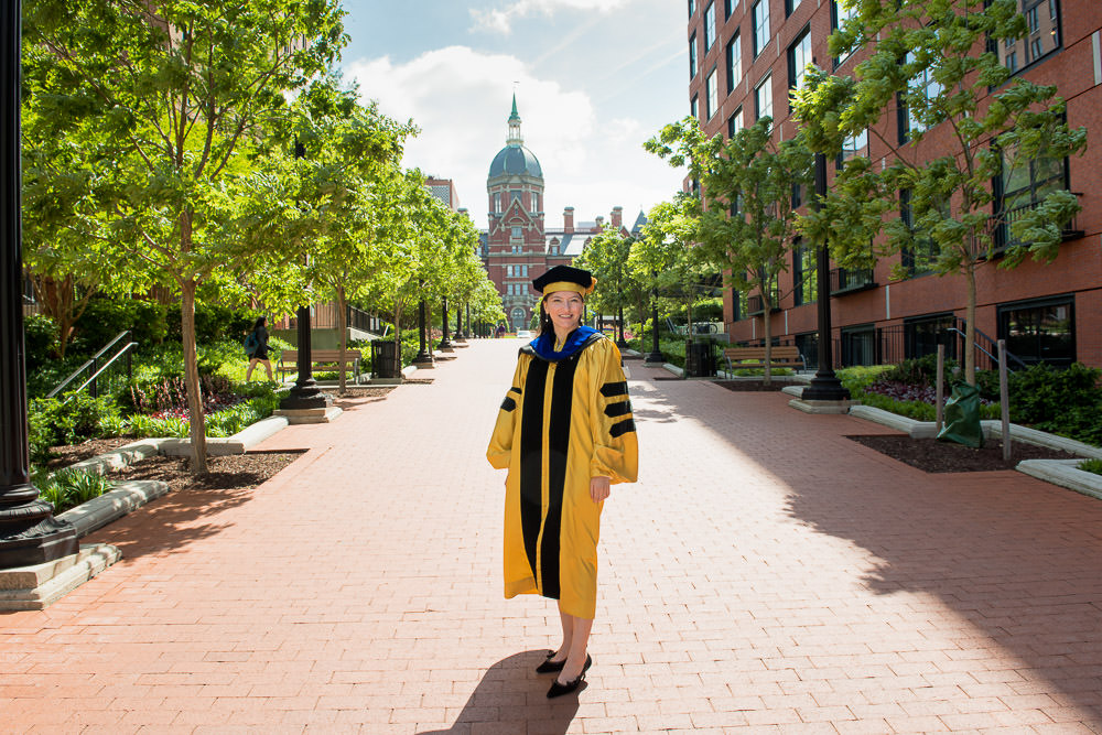 Graduation photo in front of Johns Hopkins medical campus Baltimore